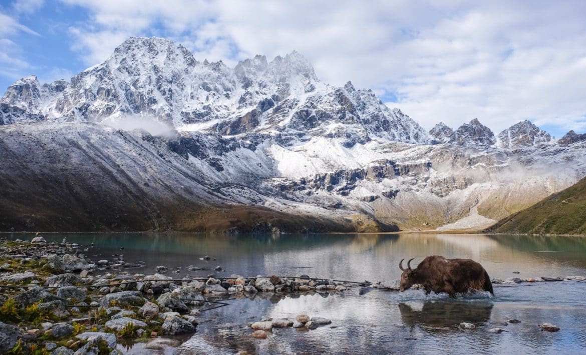 lake near snow covered mountain during daytime