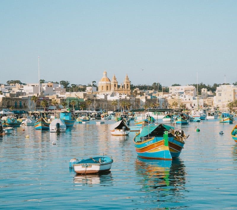 a group of boats floating on top of a body of water