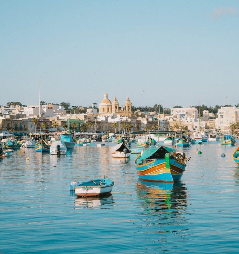 a group of boats floating on top of a body of water